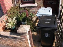 Bins dumped in front garden